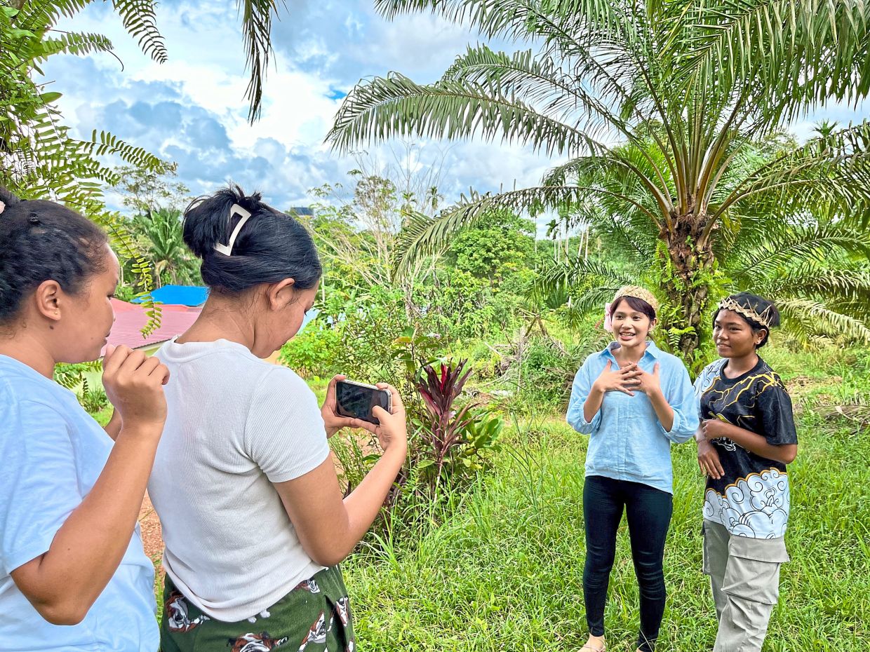 A group of Orang Asli women participating in a video content creation workshop in Kampung Petoh, Pahang. The writer says the positive use of technology has brought women from the community together. AKWOA
