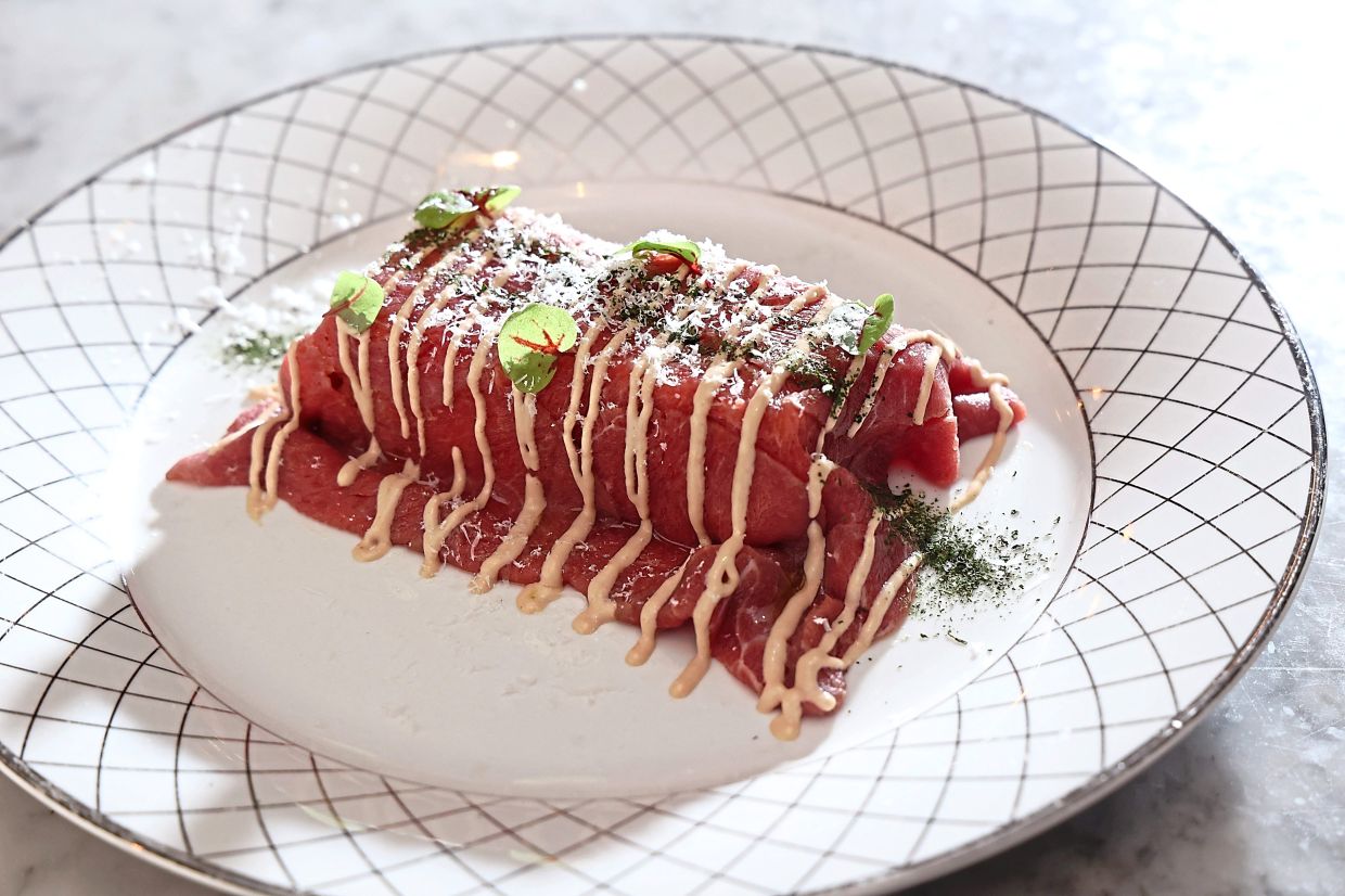 Beef tenderloin wrapped around tomato bread may sound like a questionable pairing, but it's actually a surprisingly good one. — ART CHEN/The Star