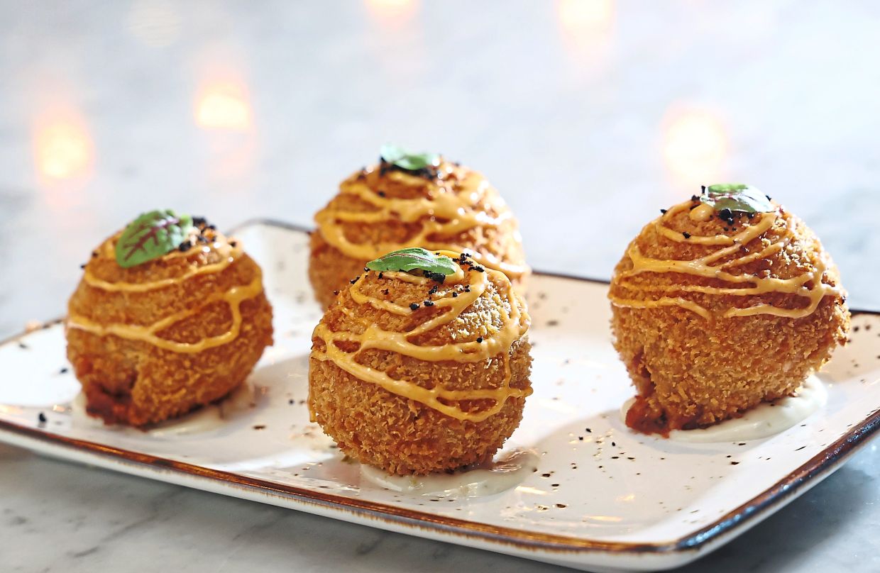Breaded and deep-fried, the calamari stuffed rolls are delicious from start to finish. — ART CHEN/The Star