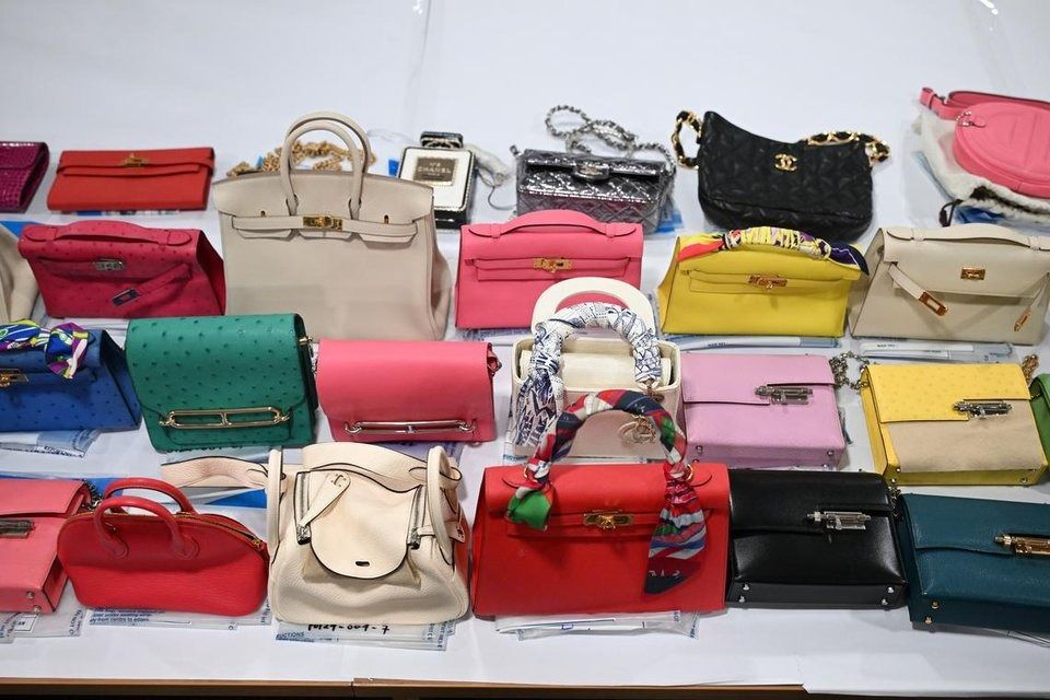 Luxury handbags from Hermes and Louis Vuitton are among the non-cash assets seized during investigations. - Photo: ST