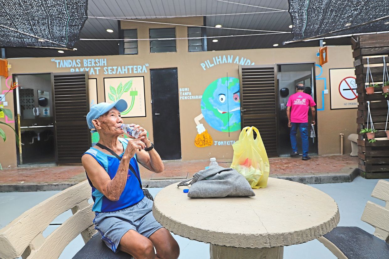 Visitor Lee Siew Hong, 77, seen outside the washroom facilities located at Air Itam Market.