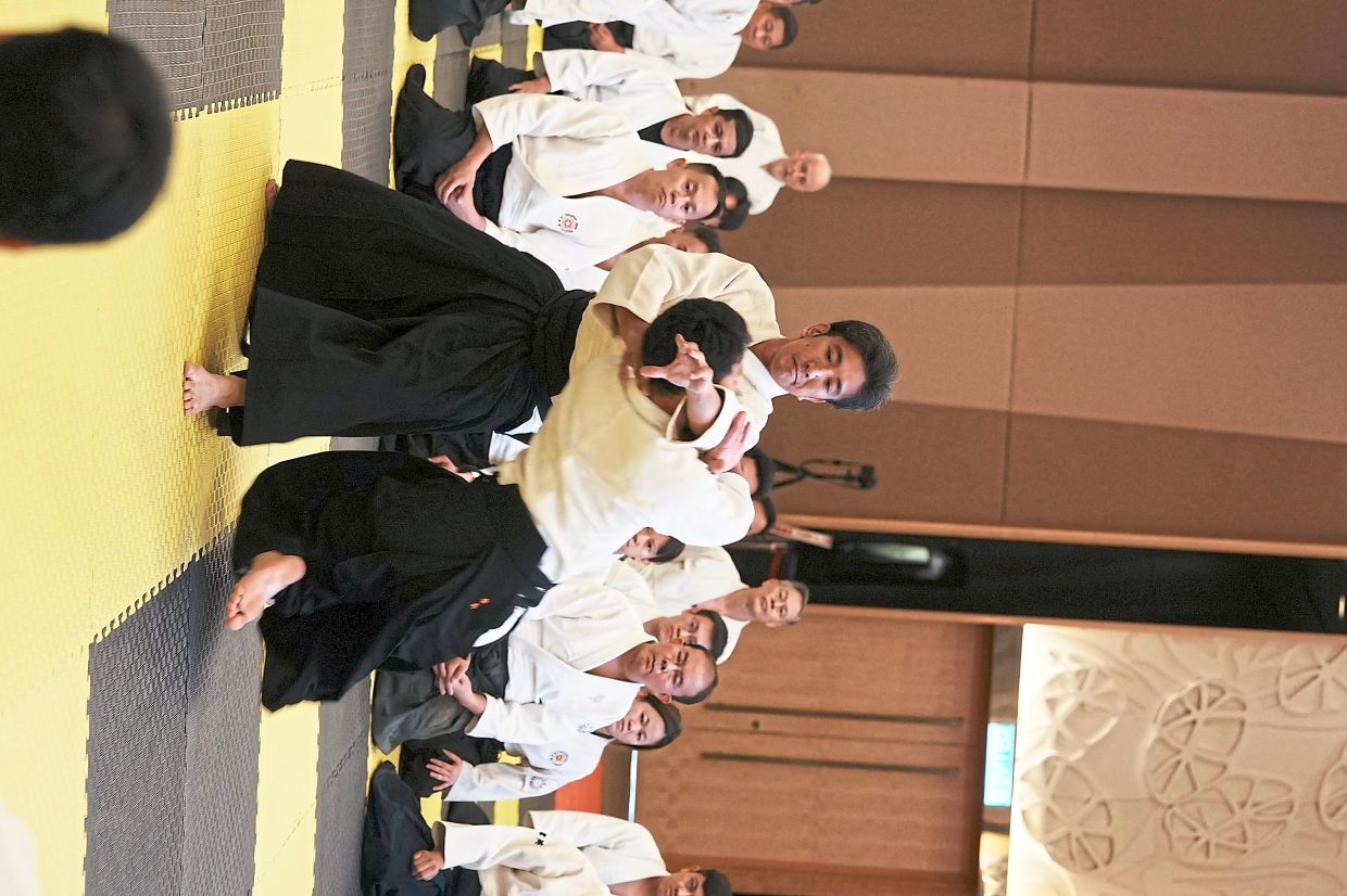 Ueshiba executing a technique during one of the demonstrations.