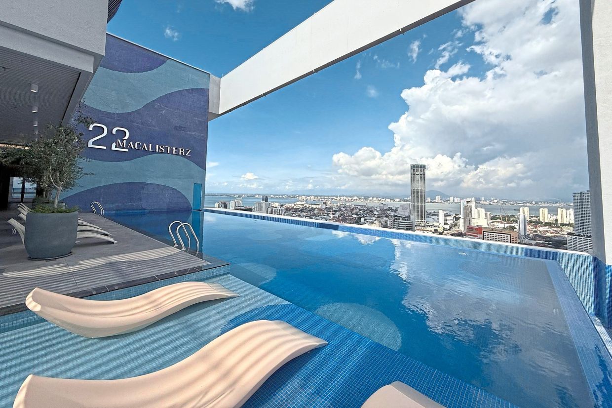 The Sky Infinity Pool offers panoramic views of the city, including the iconic Komtar (background). 