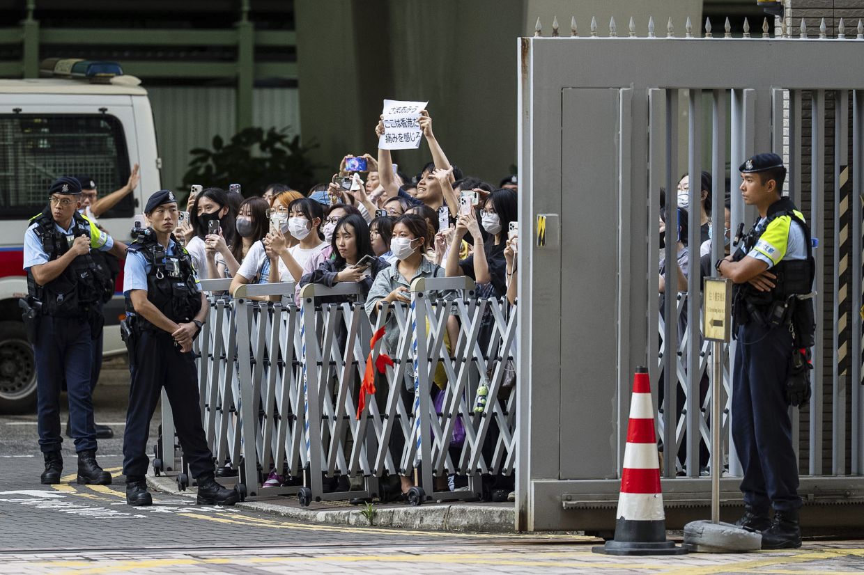 After the hearing, fans waited outside to see the idol, who did not speak before leaving in a car.