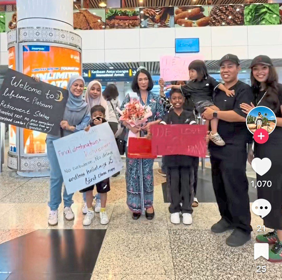 Zuhaimi (centre) is greeted by family members on her final flight.