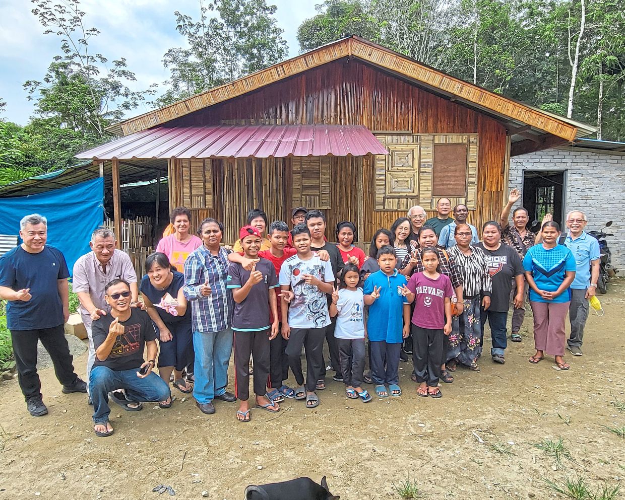 Tan (right) with his church members and the Orang Asli community from Kampung Chemperoh, Bentong, Pahang. Photo: Tan Guan Poh