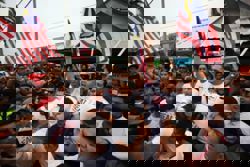 Umno Youth chief leads group of over 200 in march on barricaded shop lots