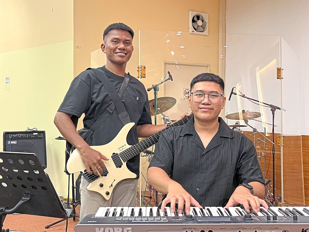 Musical cousins: Peter (left) and Paul came from humble backgrounds to master five and six musical instruments on their own after a church member introduced them to music.