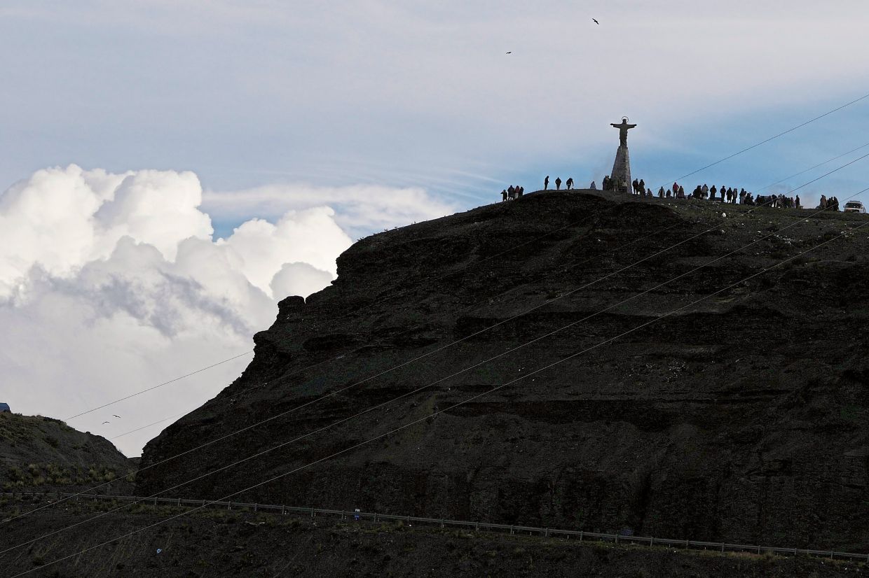 People gathering on La Cumbre, a mountain considered sacred to Indigenous folk in Bolivia. — AP