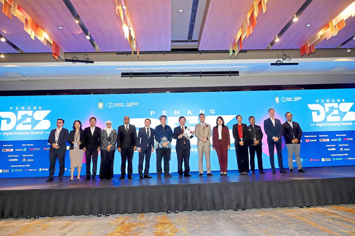 Chow (holding book) at the opening of the Penang Digital Economy Summit 2025 at G Hotel Gurney. — Photos: LIM BENG TATT/The Star