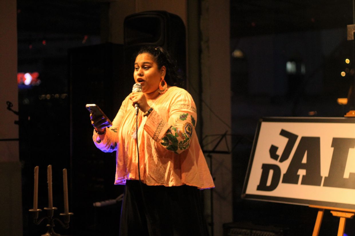 Last year’s Poetry Slam winner, Kasthury, returns as the ‘sacrificial poet,’ guiding aspiring competitors. Photo: Jalan Dalam