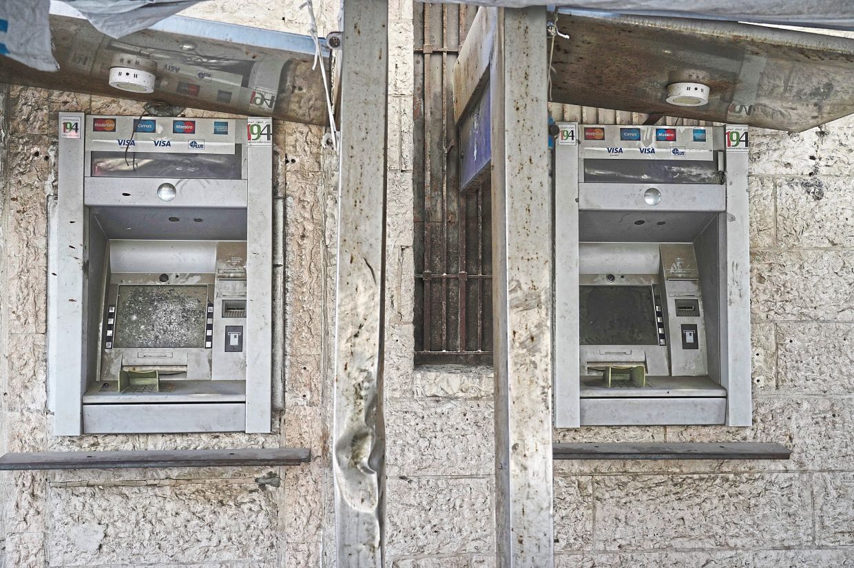 Broken Arab Bank ATMs in Gaza City. — AP