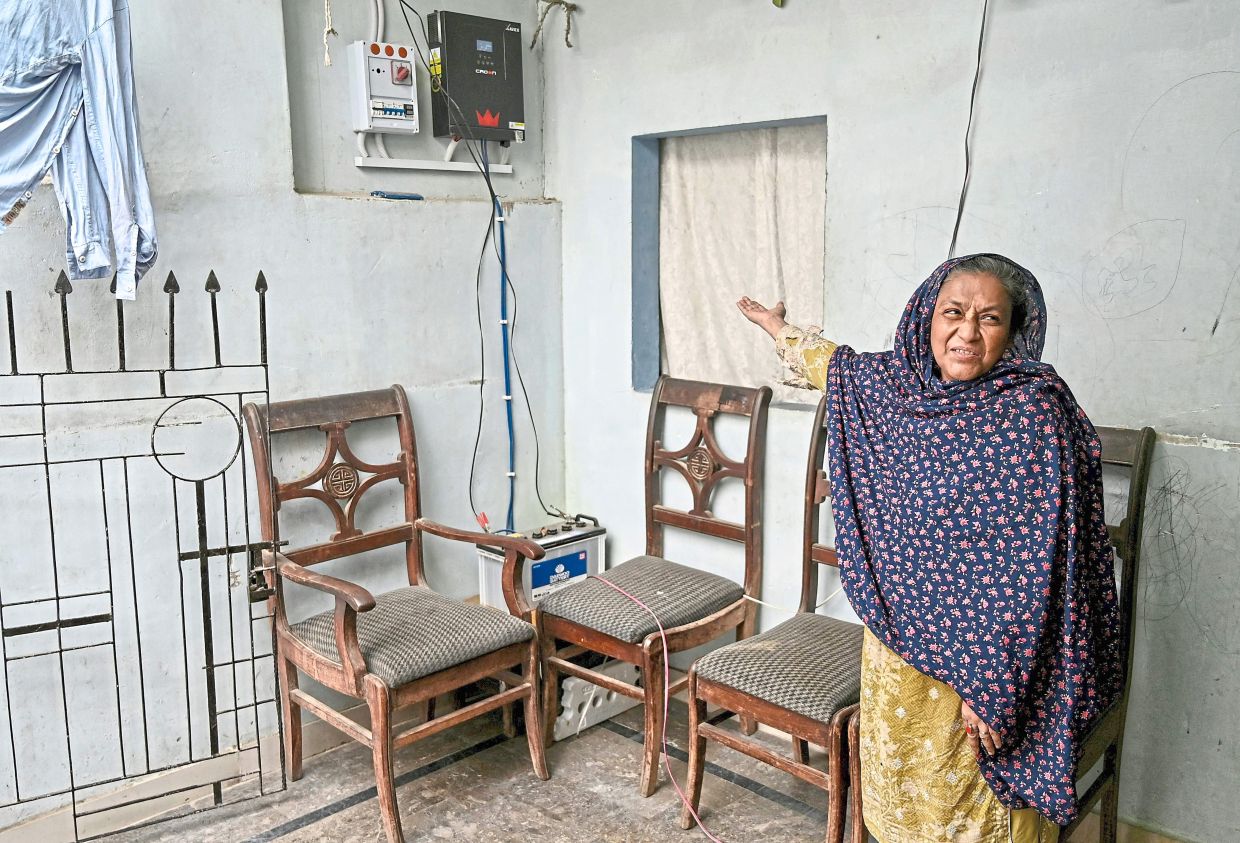 Fareeda enjoying ‘uninterrupted power’ after installing an inverter at her home in Karachi. — AFP