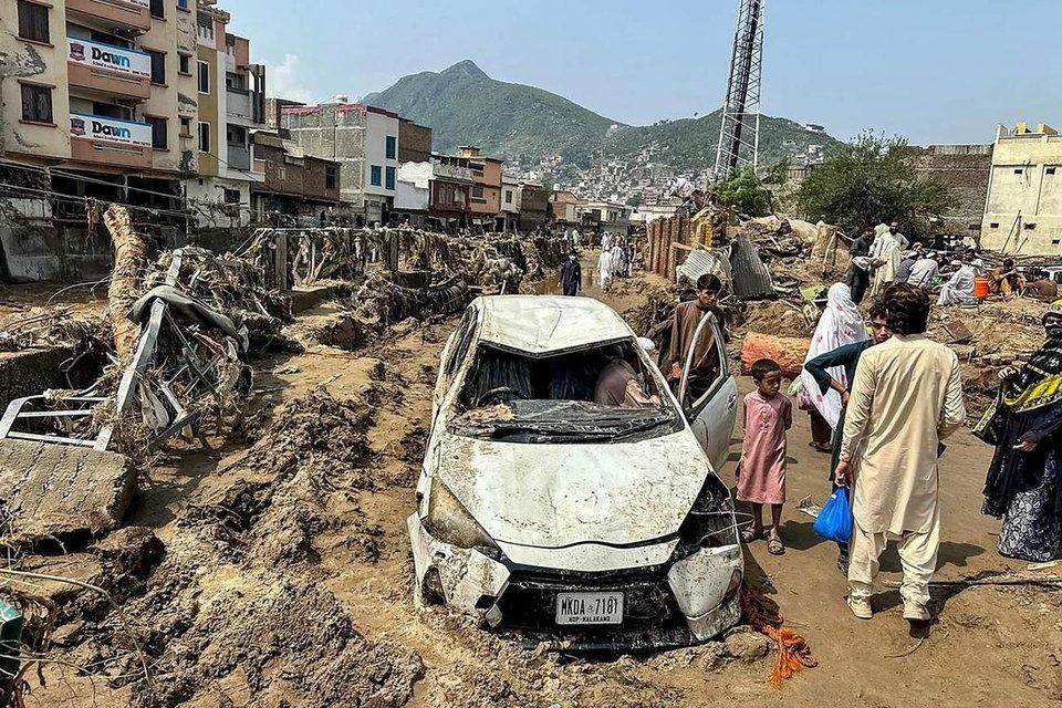 A damaged vehicle after a flash flood in Mingora, Pakistan, on Aug 16. - Photo: AFP