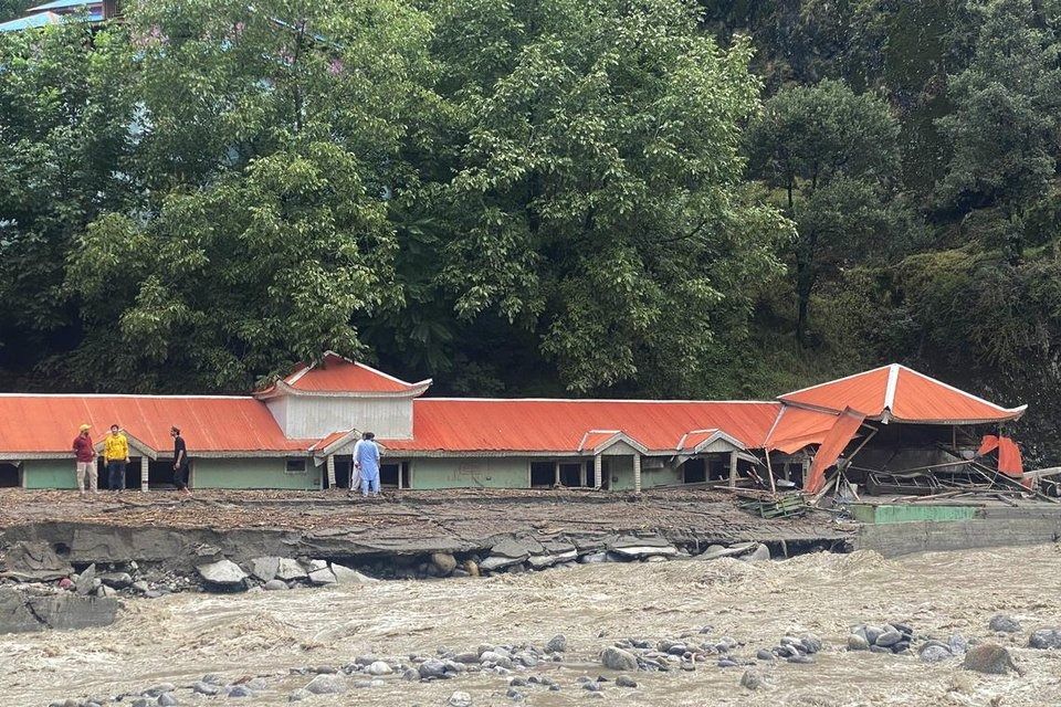 People surveying damage caused by flash floods in Neelum Valley, in Pakistan-administered Kashmir, on Aug 15. - Photo: EPA