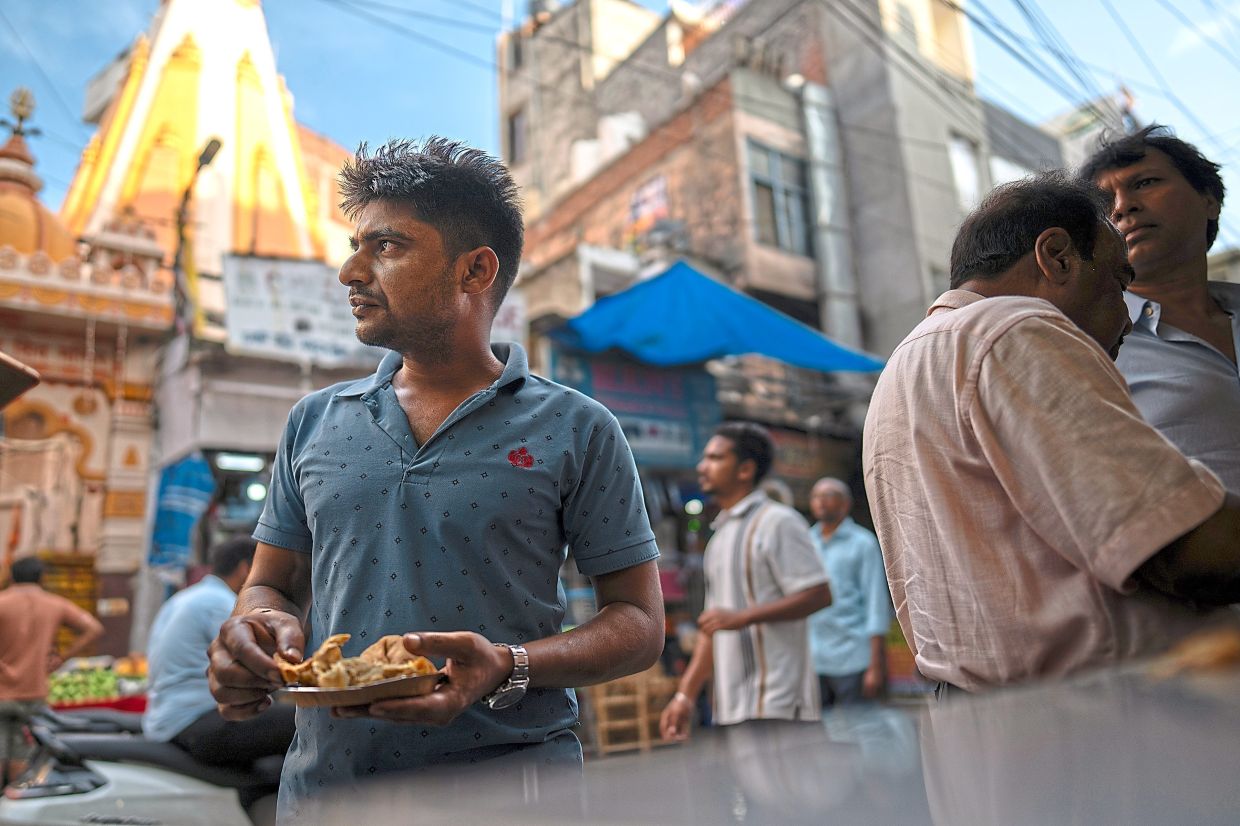 Samosas are Dheeraj Sharma’s snack of choice because they are tasty and cheap.