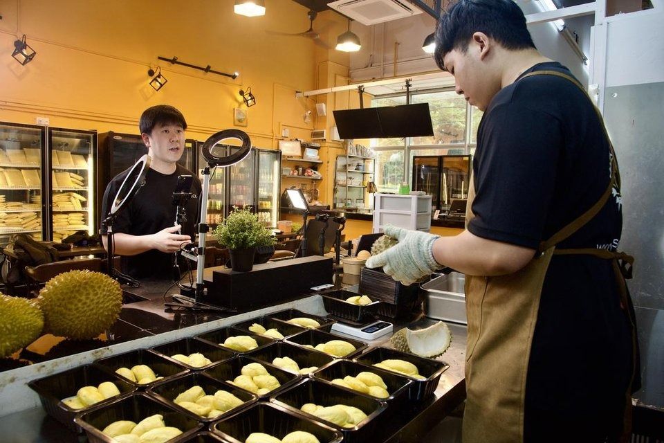 The Vlack Durian team takes turns to live stream its durians on TikTok Shop. - Photo: ST