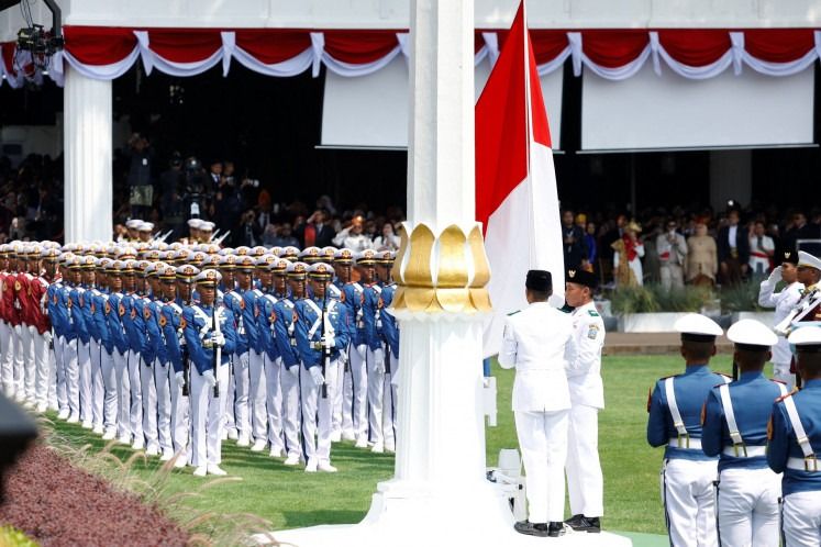 Three members of the national flag-hoisting team raise the Red-and-White flag on Aug. 17, 2025, during a ceremony to commemorate Indonesia's 80th anniversary at the State Palace in Jakarta. - Photo: Reuters