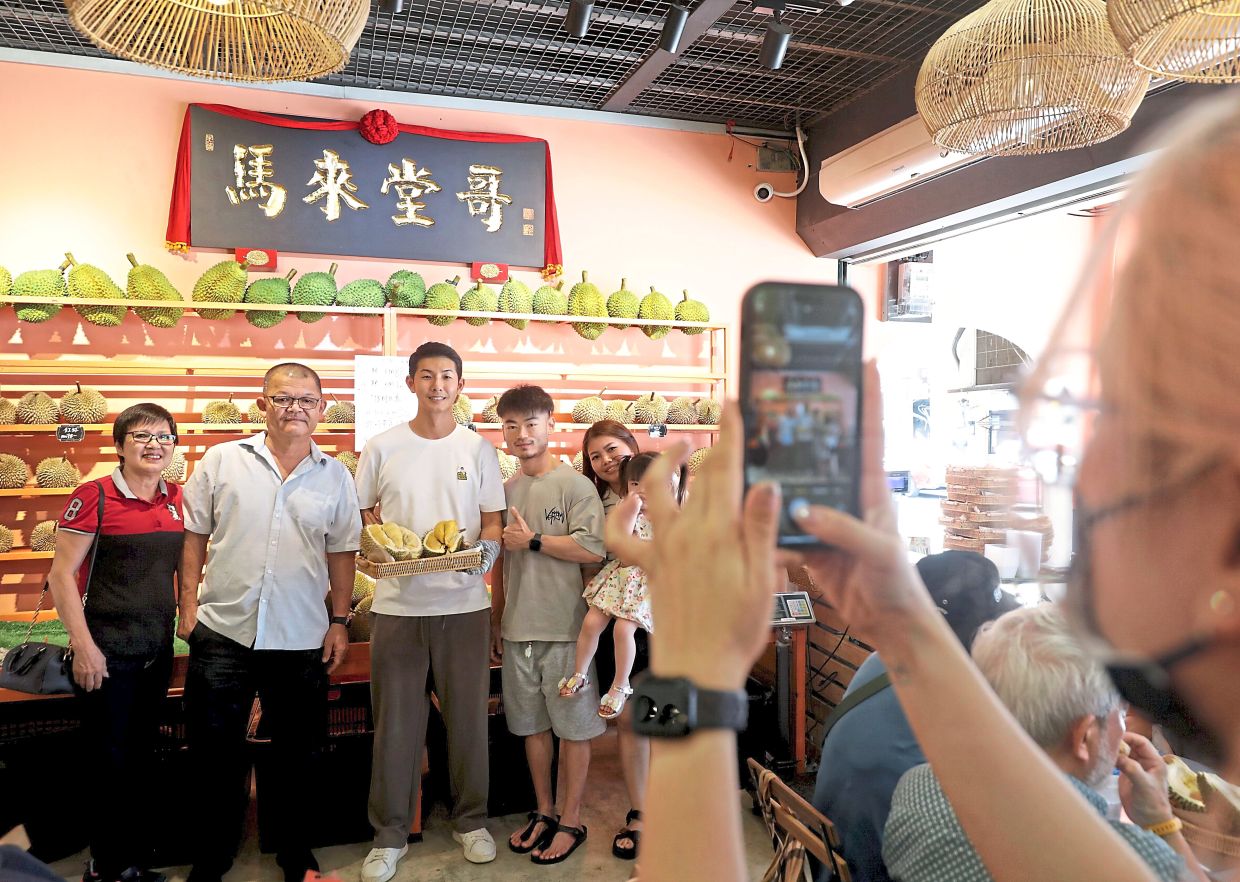 Ang's followers travel from all over China and Malaysia to try the durian at his shop and meet him too, as he's something of a celebrity. — SAMUEL ONG/The Star