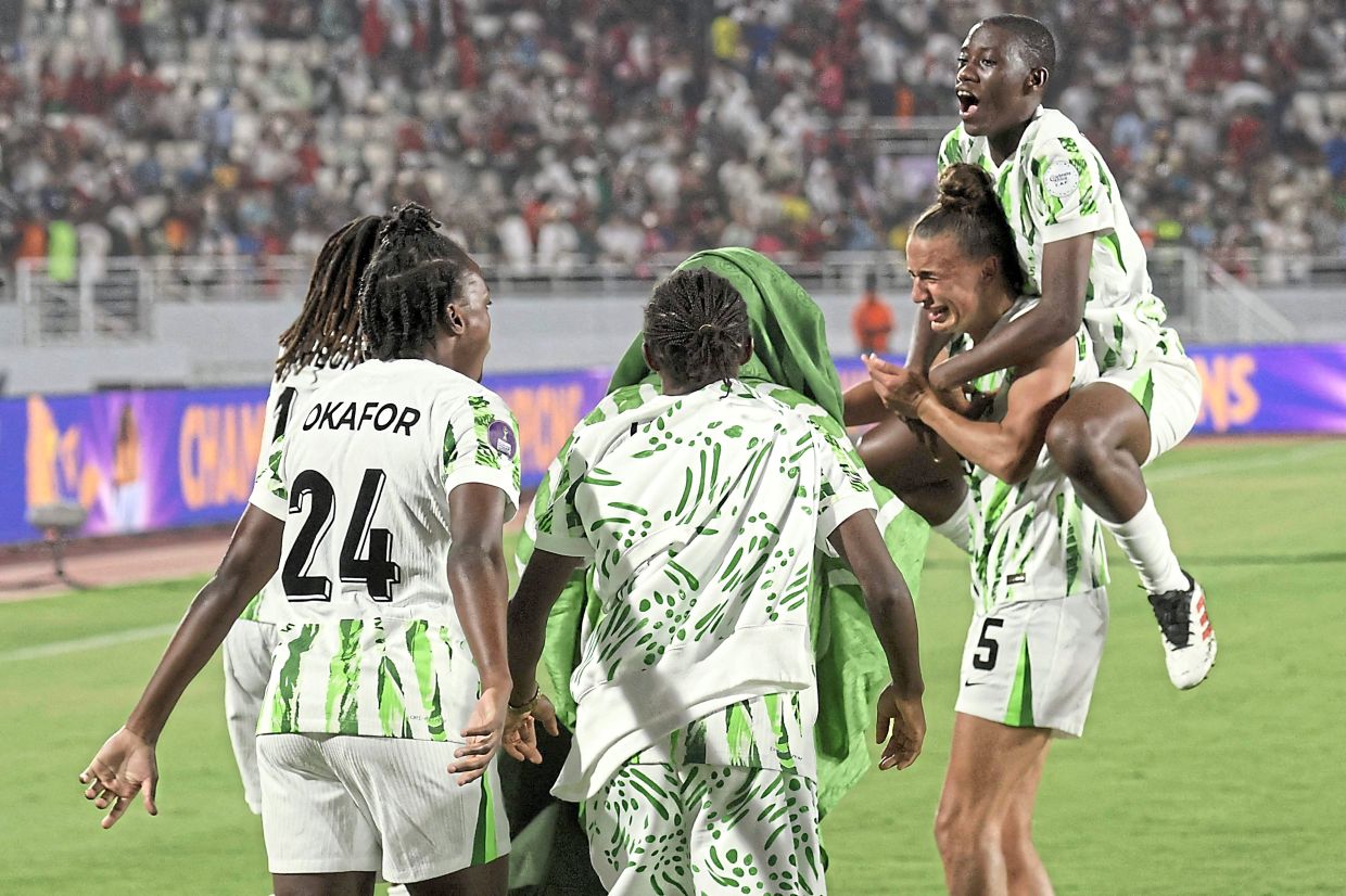 Nigeria players jubilate after their 3-2 win over Morocco. — AFP