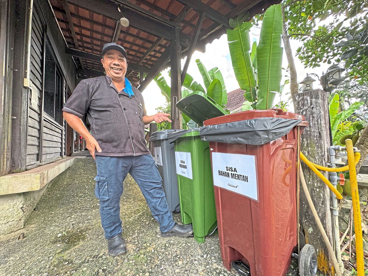 A staff member at Zaid’s restaurant in Batu 18 separating wastes at source. Food waste, which makes up 70% of rubbish at the restaurant, is composted into plant fertiliser.
