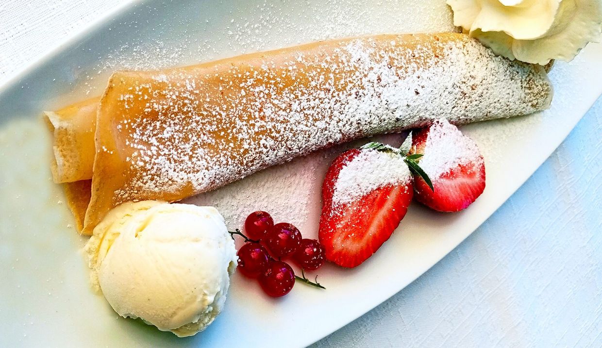 Apricot crepe ala mode is a classic dessert that incorporates seasonal local fruits.
