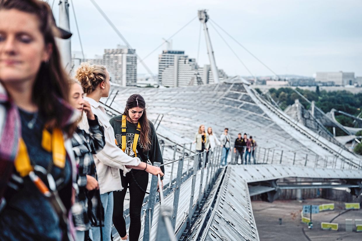 From the tent roof of Munich’s Olympic Stadium, the view extends far beyond the city. — Olympiapark Munchen GmbH/dpa