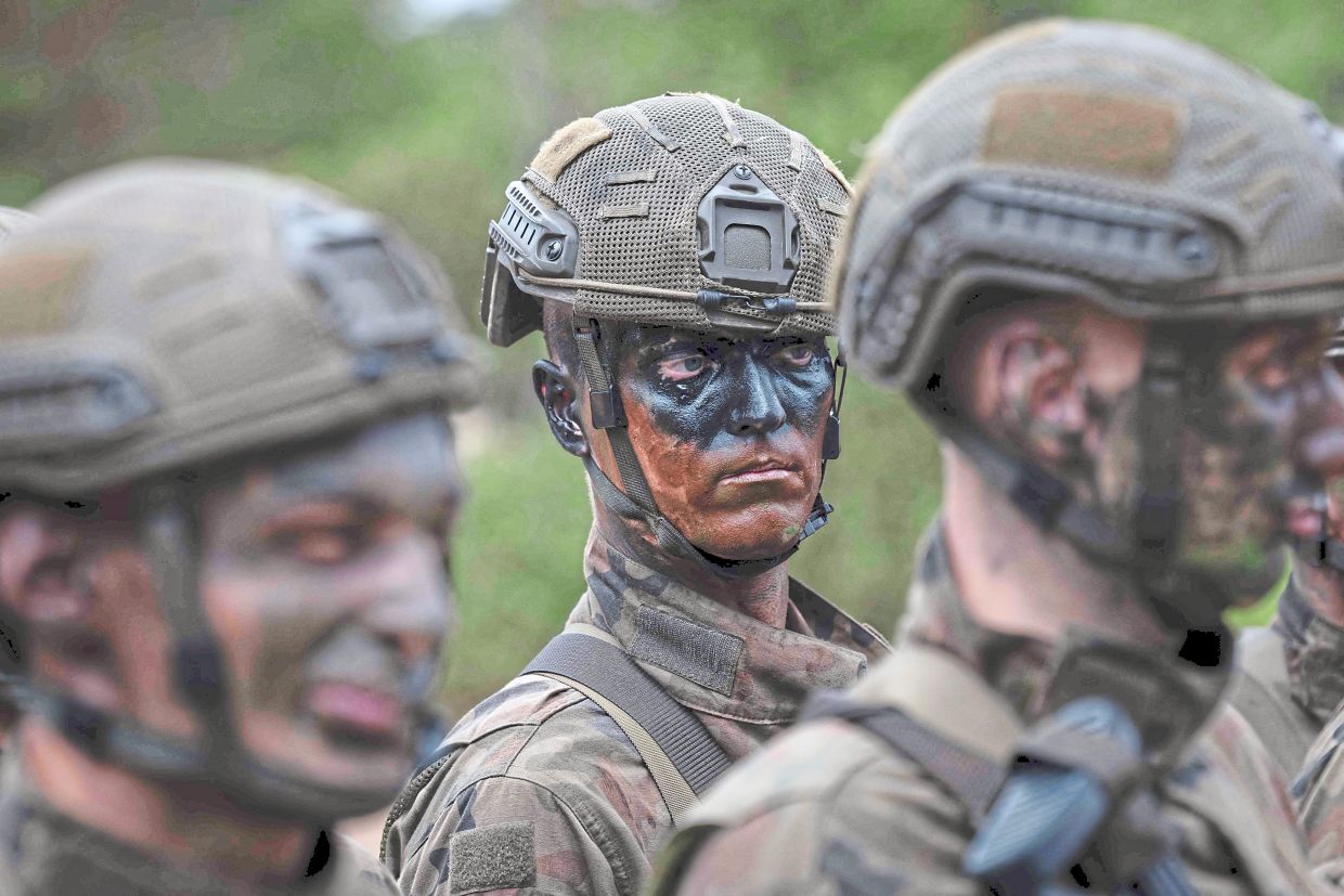 Piekut (centre) takes part in the ‘Holidays with the Army’ military training project on the outskirts of Warsaw. — AFP