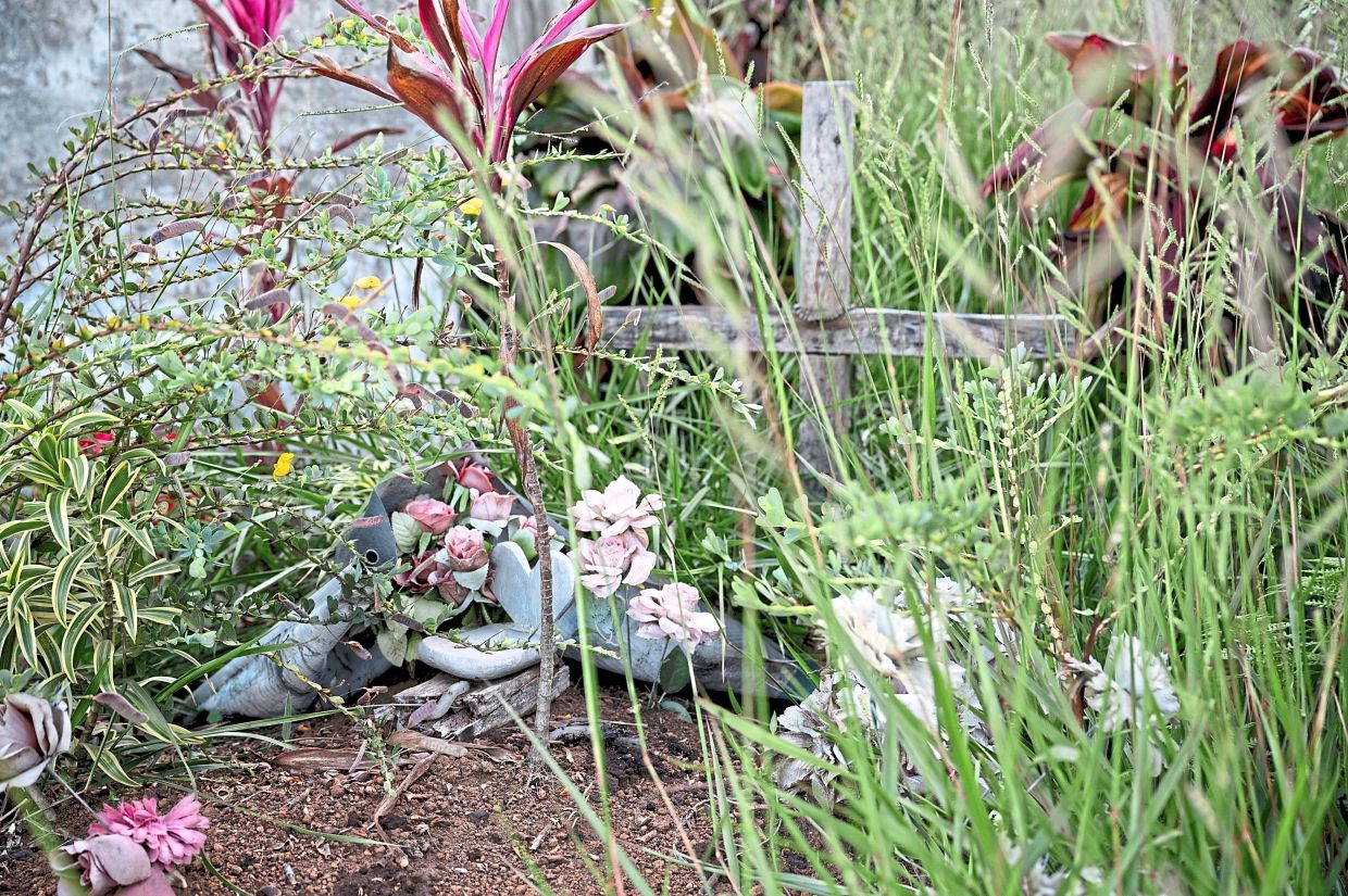 Flowers sit at the grave of Cucuname, a community member killed at age 14 three years ago, in a confrontation with dissidents from the FARC.