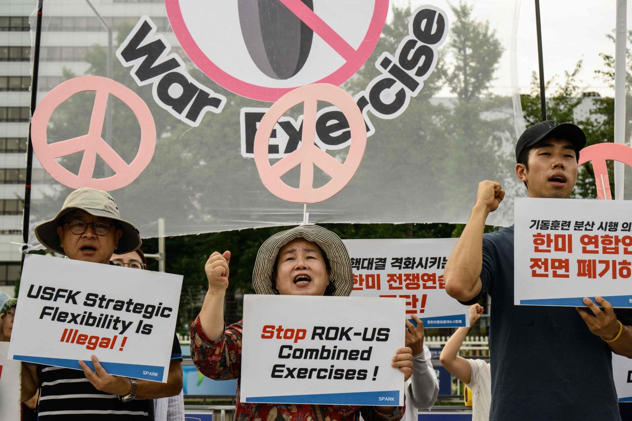 Protesters shout slogans as they rally against the Ulchi Freedom Shield (UFS), an annual joint military exercise between the United States and South Korea, in front of the presidential office in Seoul on Monday, August 18, 2025. -- Photo by ANTHONY WALLACE / AFP