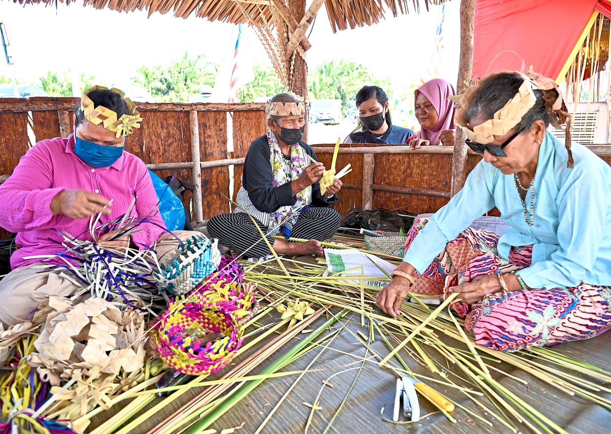 Artisans from the Temuan tribe showcasing the traditional craft of weaving.