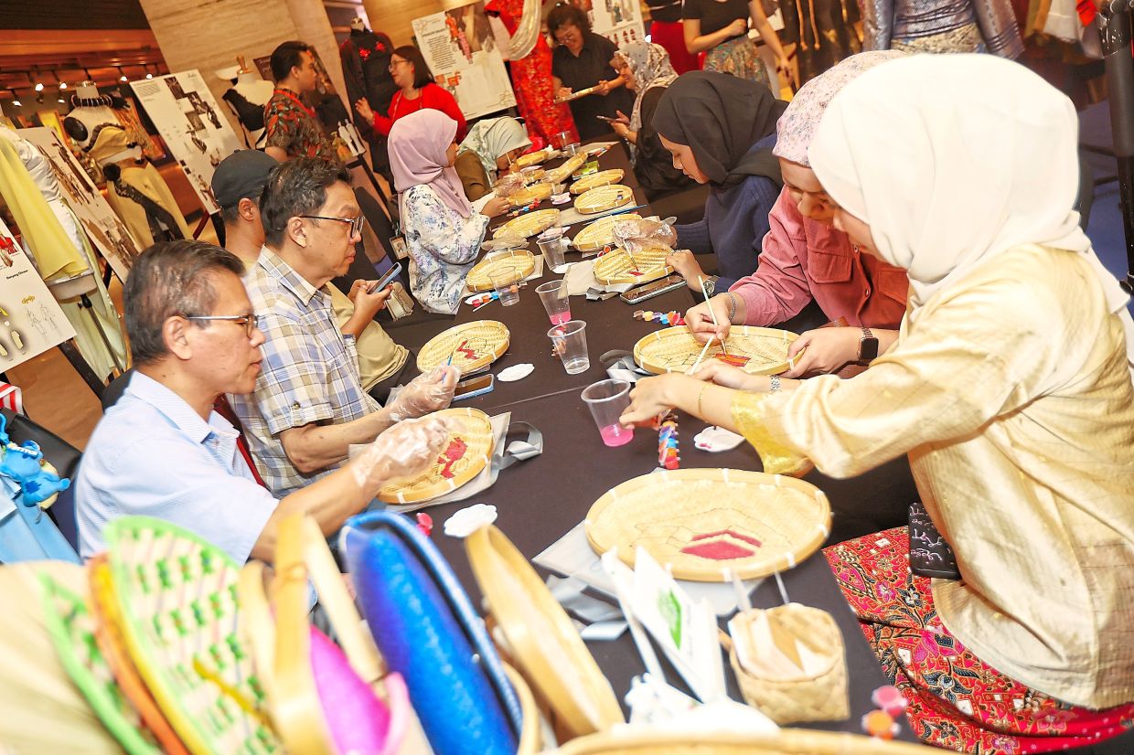 Members of the media taking part in a painting workshop during the event at Intermark Mall.