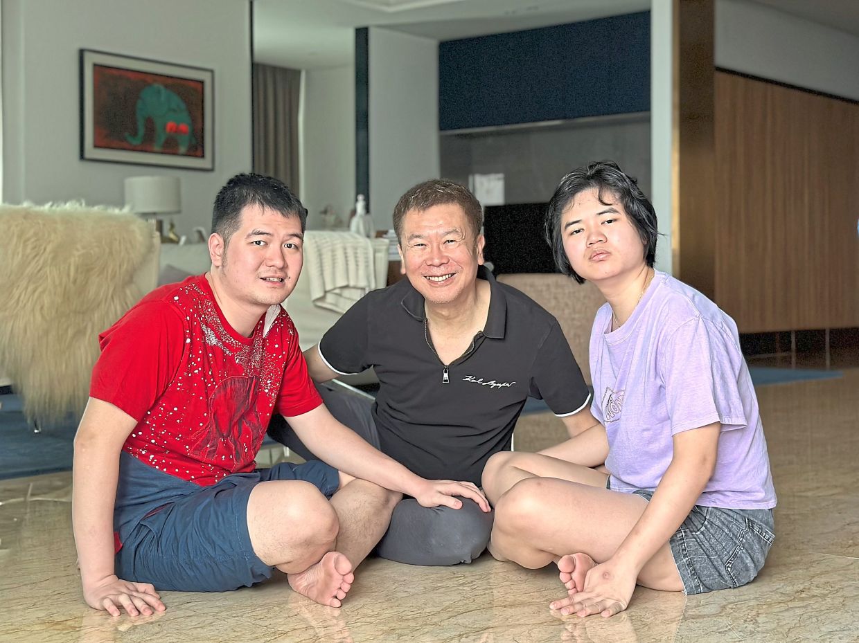 Ng with his children, Sean (left) and Tania, who inspired his support for autism initiatives. Sim’s aluminium print of a puffin from the Faroe Islands will be featured in the exhibition. Photos: Ng Wy Min 