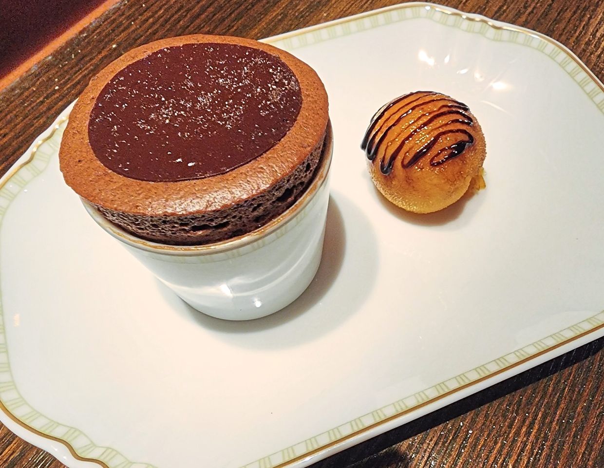 The chocolate souffle is a bewitching temptress juxtaposed against an astringent blood orange reduction.