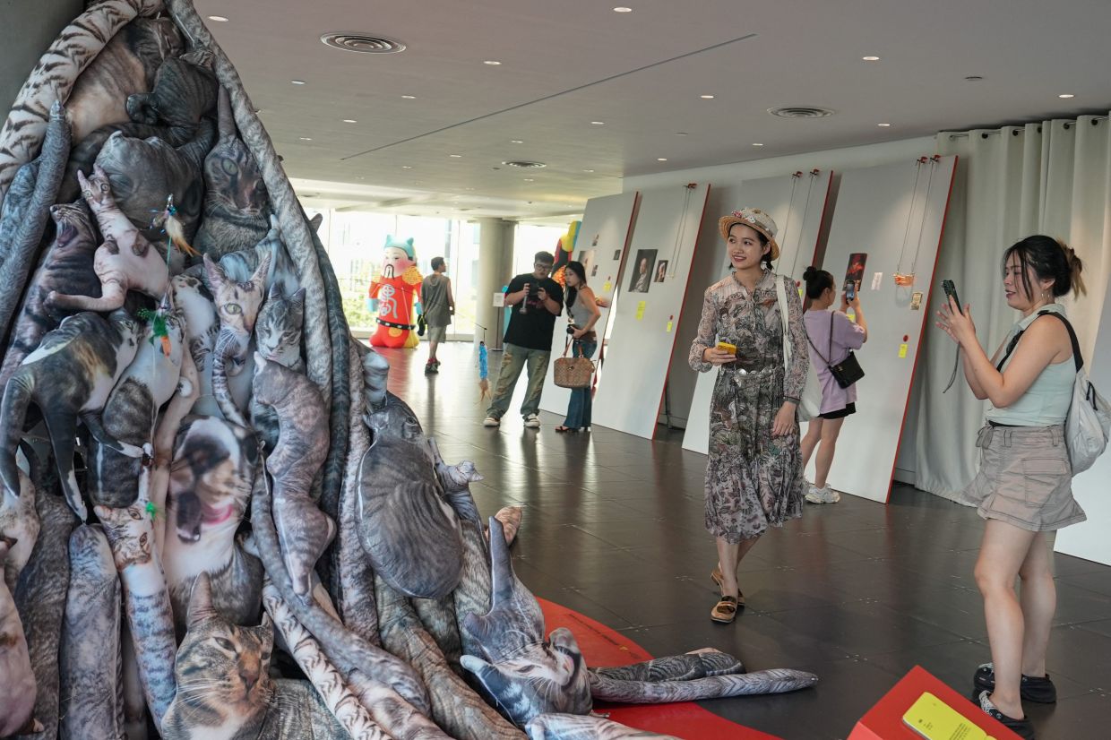 People visit the exhibition 'Era of Uglies Has Arrived' by Alibaba's Taobao, in Hangzhou, Zhejiang province, China August 13, 2025. REUTERS/Nicoco Chan