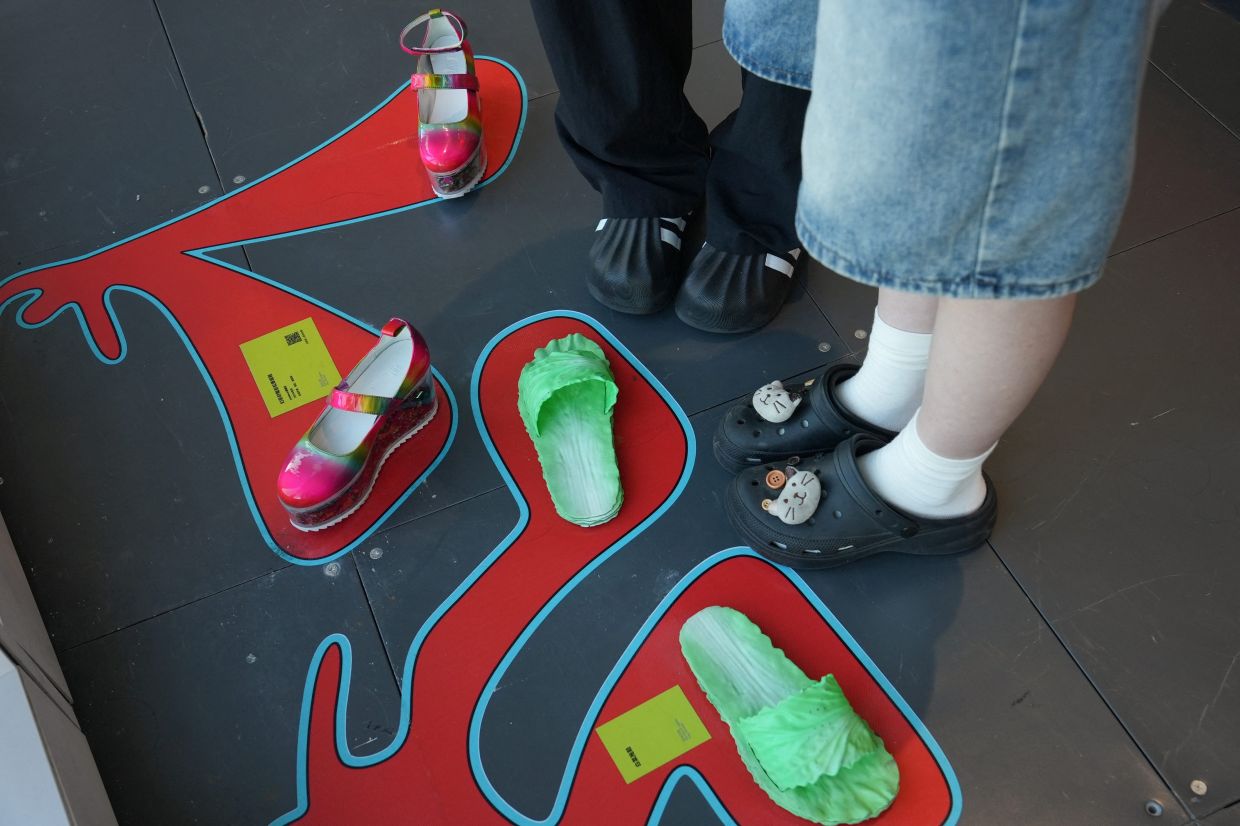 People visit the exhibition 'Era of Uglies Has Arrived' by Alibaba's Taobao, in Hangzhou, Zhejiang province, China August 13, 2025. REUTERS/Nicoco Chan