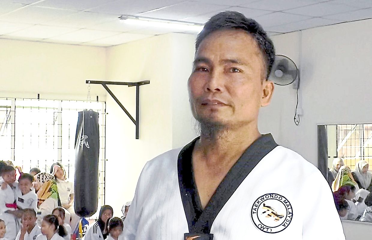 Ahmad Khalid has been teaching taekwondo in Sandakan since 1990, training students of all ages — including seniors like Khong.