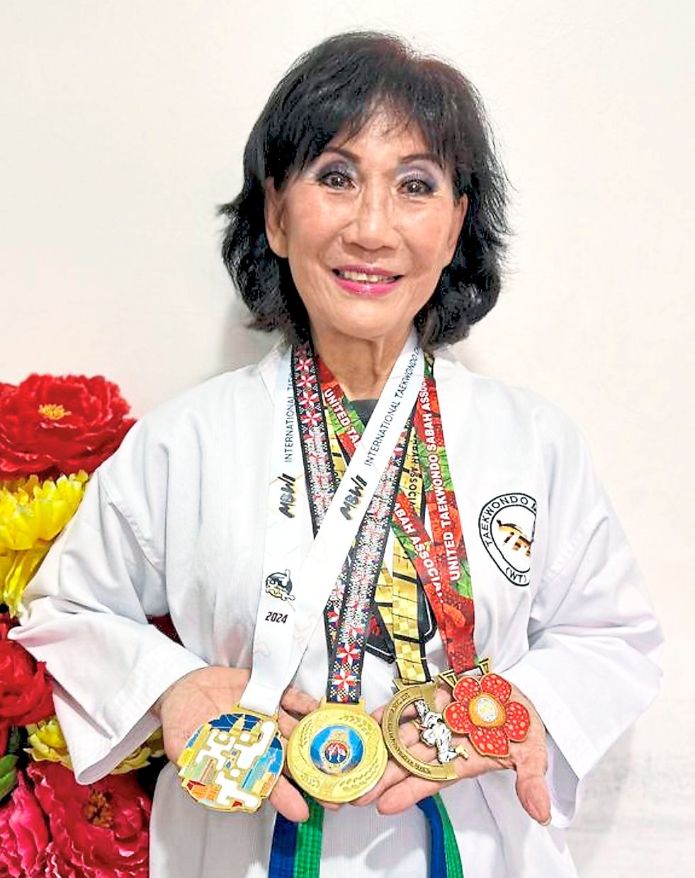 Khong displaying the gold medals she won in taekwondo competitions across Malaysia since picking up the sport a year ago.