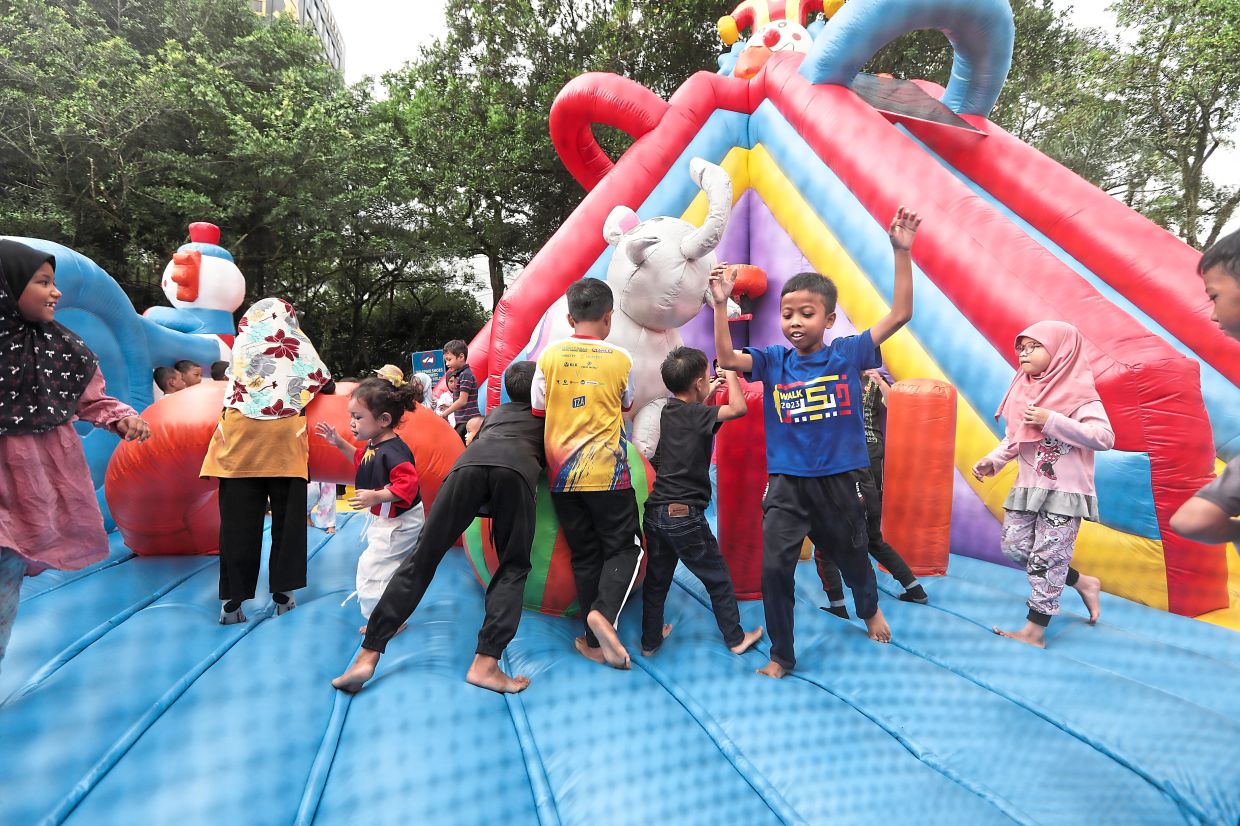 Children having a fun time bouncing around at the inflatable playground.