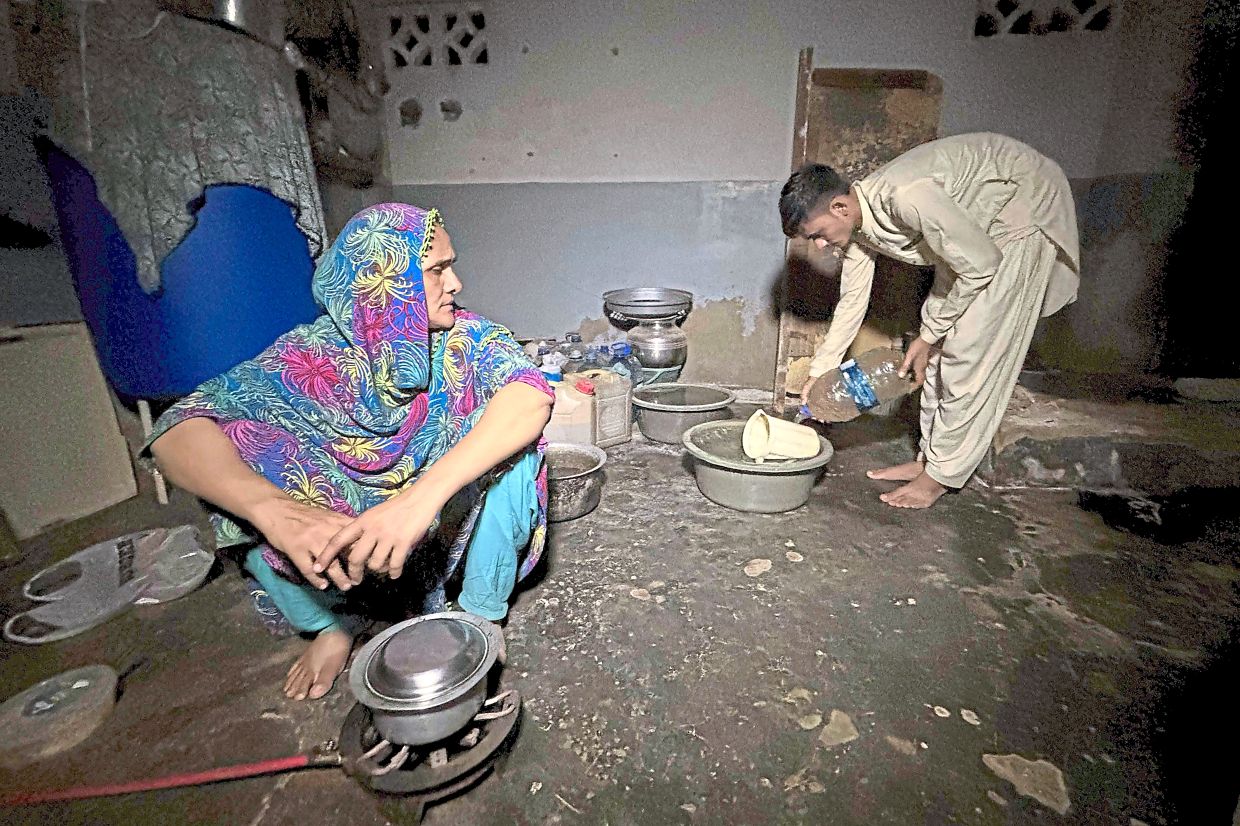 aryam and Ahmed working in the kitchen in their house in Karachi, both not registered with National Database and Registration Authority. Ahmed is invisible in the eyes of his government, unable to study or work, because like millions of other Pakistanis, he lacks identification papers. — AFP