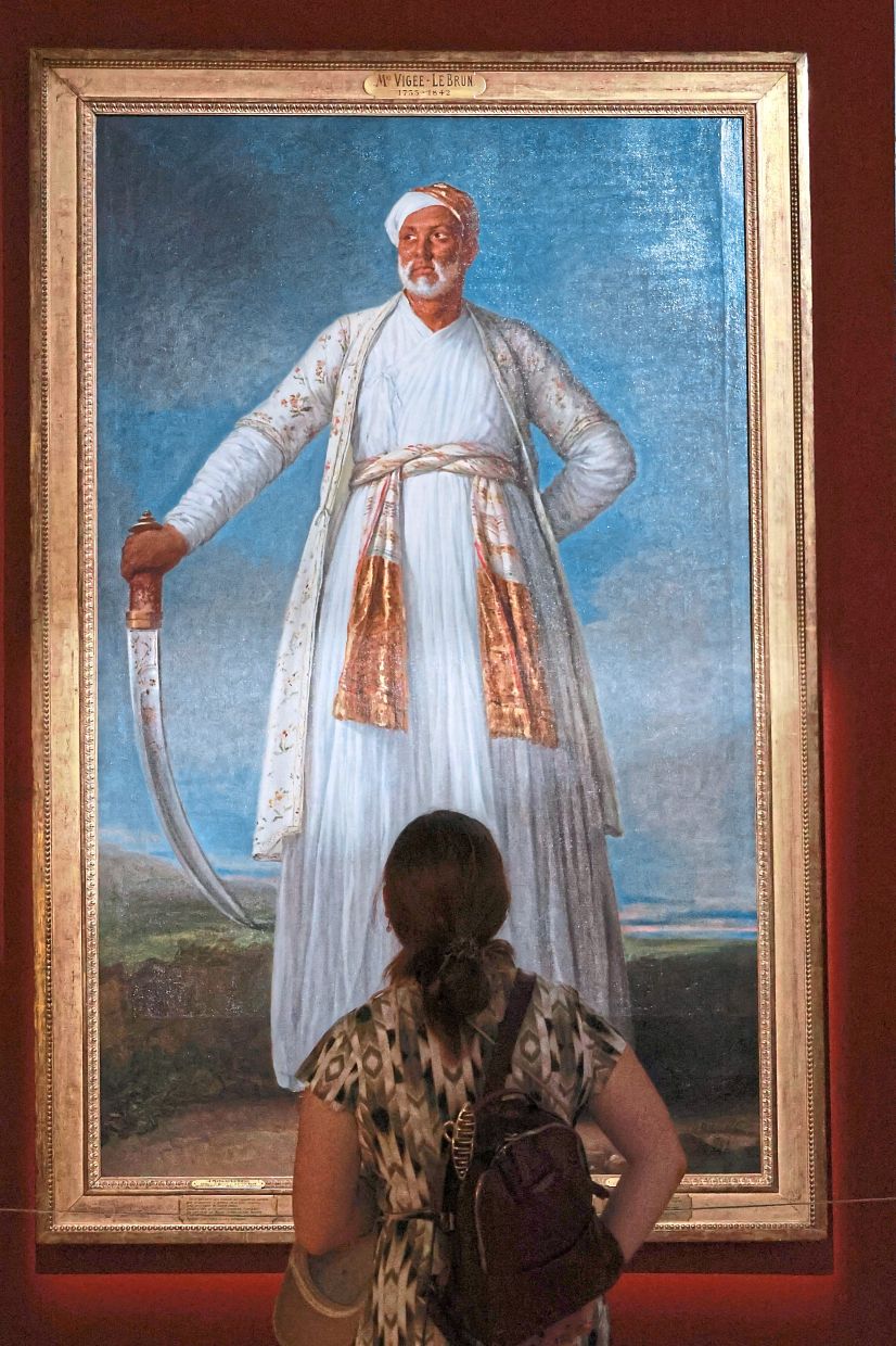 A visitor admires an 1788 portrait of Tipu’s ambassador to France, Muhammad Dervish Khan, painted by Elisabeth Vigee Le Brun. Photo: The Star/Kamarul Ariffin