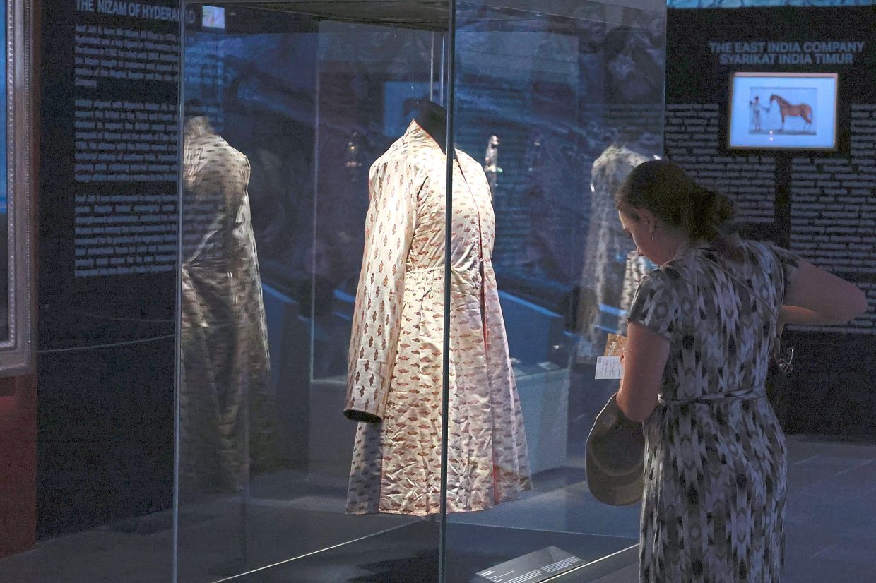 Alongside treasures, weapons, manuscripts, documents, and paintings, the exhibition also showcases royal garments from the era. Photo: The Star/Kamarul Ariffin