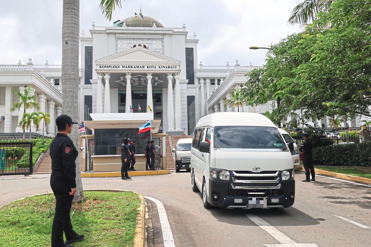 Facing the law: A vehicle believed to be carrying five teenagers facing charges of using abusive language against Zara Qairina last month seen leaving the premises of the Kota Kinabalu Court Complex. — Bernama