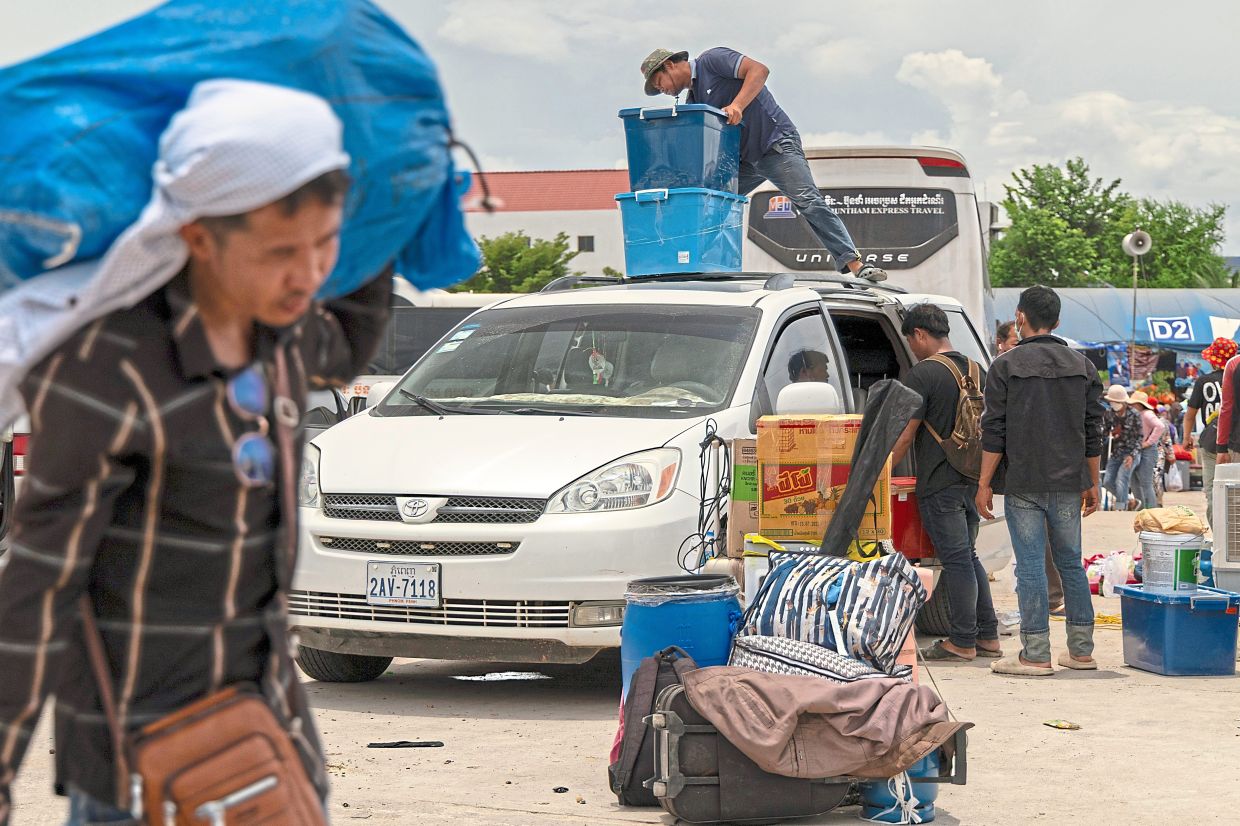 Going home: Migrant workers re-enter Cambodia through the Daung International Border Gate in Kamrieng.— AP