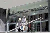 NZ central bank cuts rates to three-year low