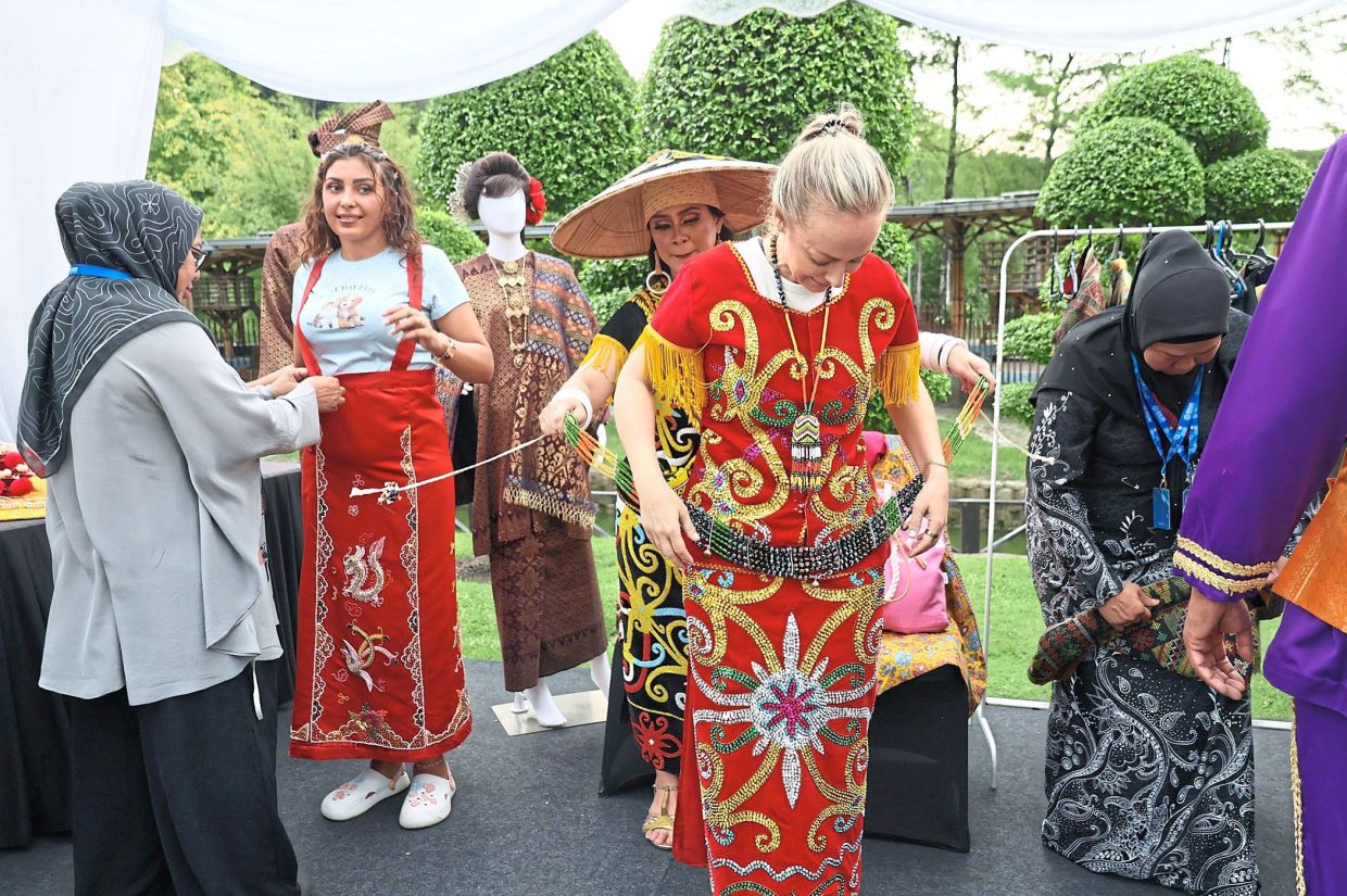 Guests at the dinner trying on traditional attire.