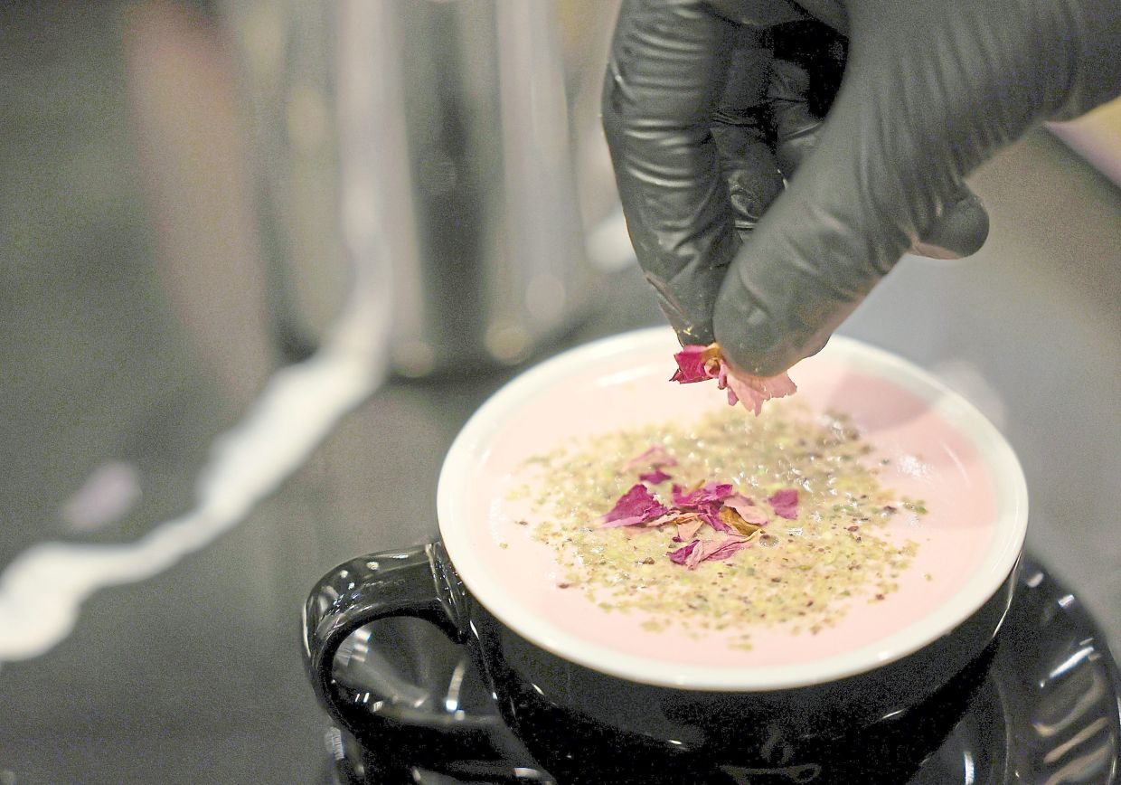 Yemeni coffee shops offer their own take on coffee, such as edible flower petals atop a cup of chai latte.