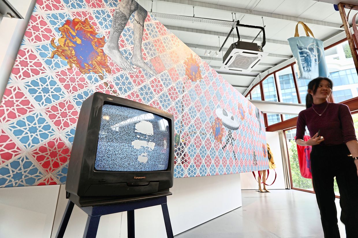 Sanan's new artworks – 'Echo TV' (multimedia sculpture) and 'Hanuman, Buddhas And The Priest (screen print and acrylic paint on canvas) – at the 'Society: Work In Progress' exhibition at Tali Art Gallery in Petaling Jaya. Photo: The Star/Low Lay Phon