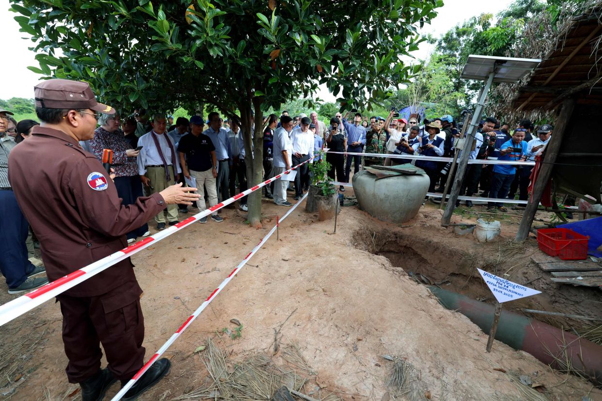 A bomb dropped by the Thai military during the July border clashes between Cambodia and Thailand in a village in Oddar Meanchey province is seen in this photo taken on Aug 22. - AFP