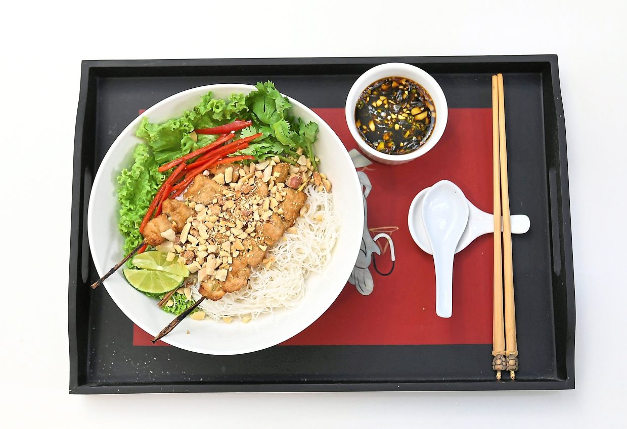 Charred lemongrass chicken over a nest of rice vermicelli, dressed with herbs and peanuts is a true taste of Vietnam. — Photos: ONG SOON HIN/The Star